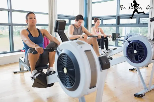 two runners on rowing machines in the gym to prevent injury